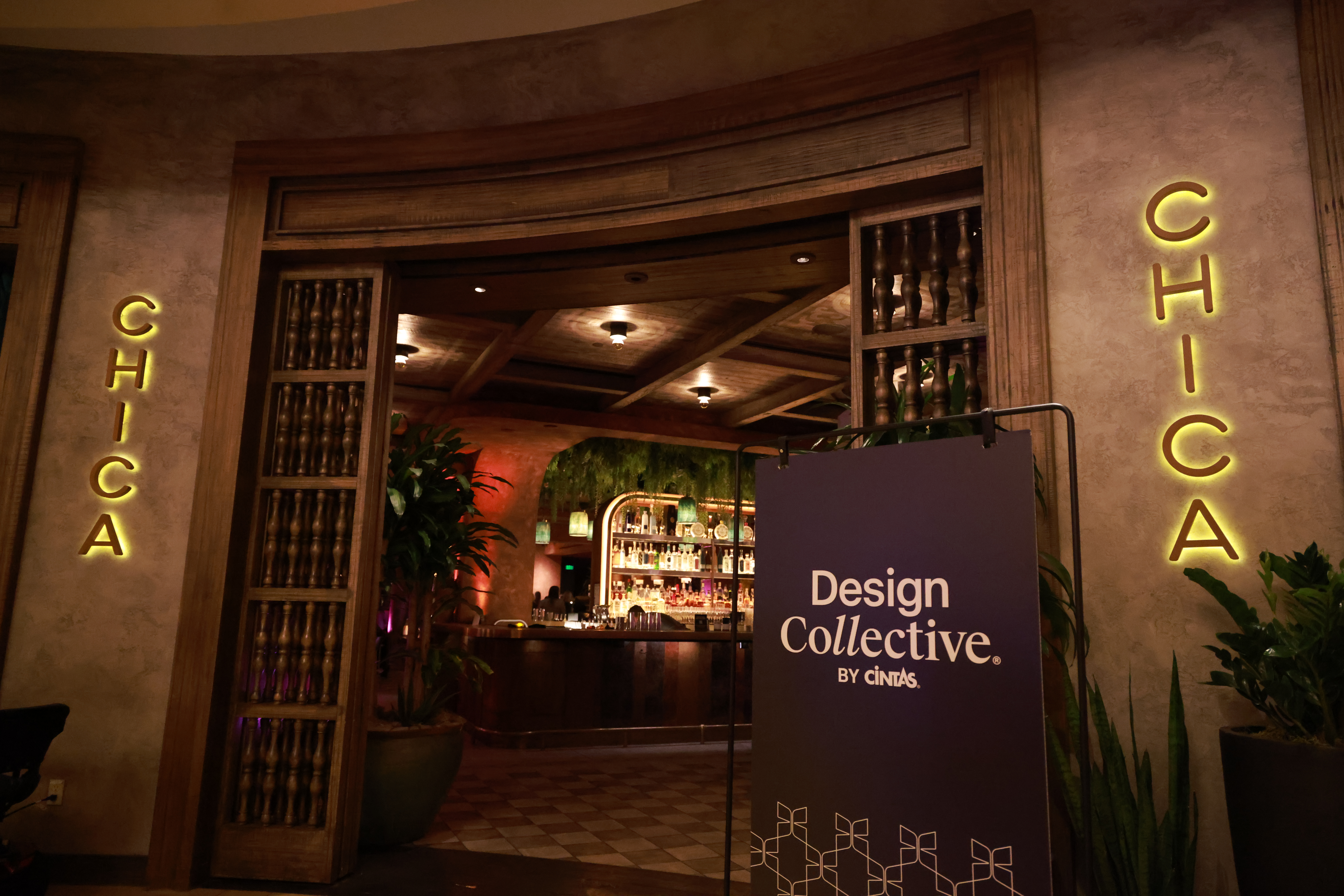 Outfitted for<br><span><i>A-game</i></span> Entrance to CHICA restaurant, with its name illuminated on the wall and a